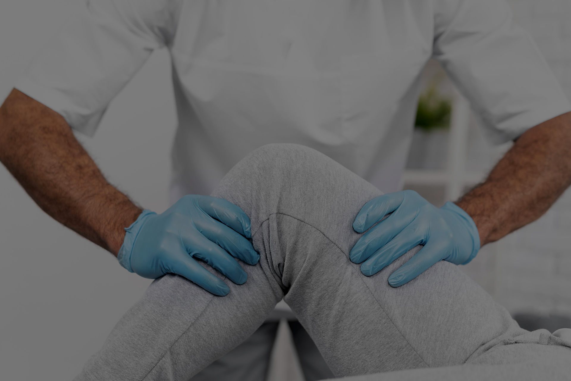 person with knee pain having their knee examined by the chiroprctor