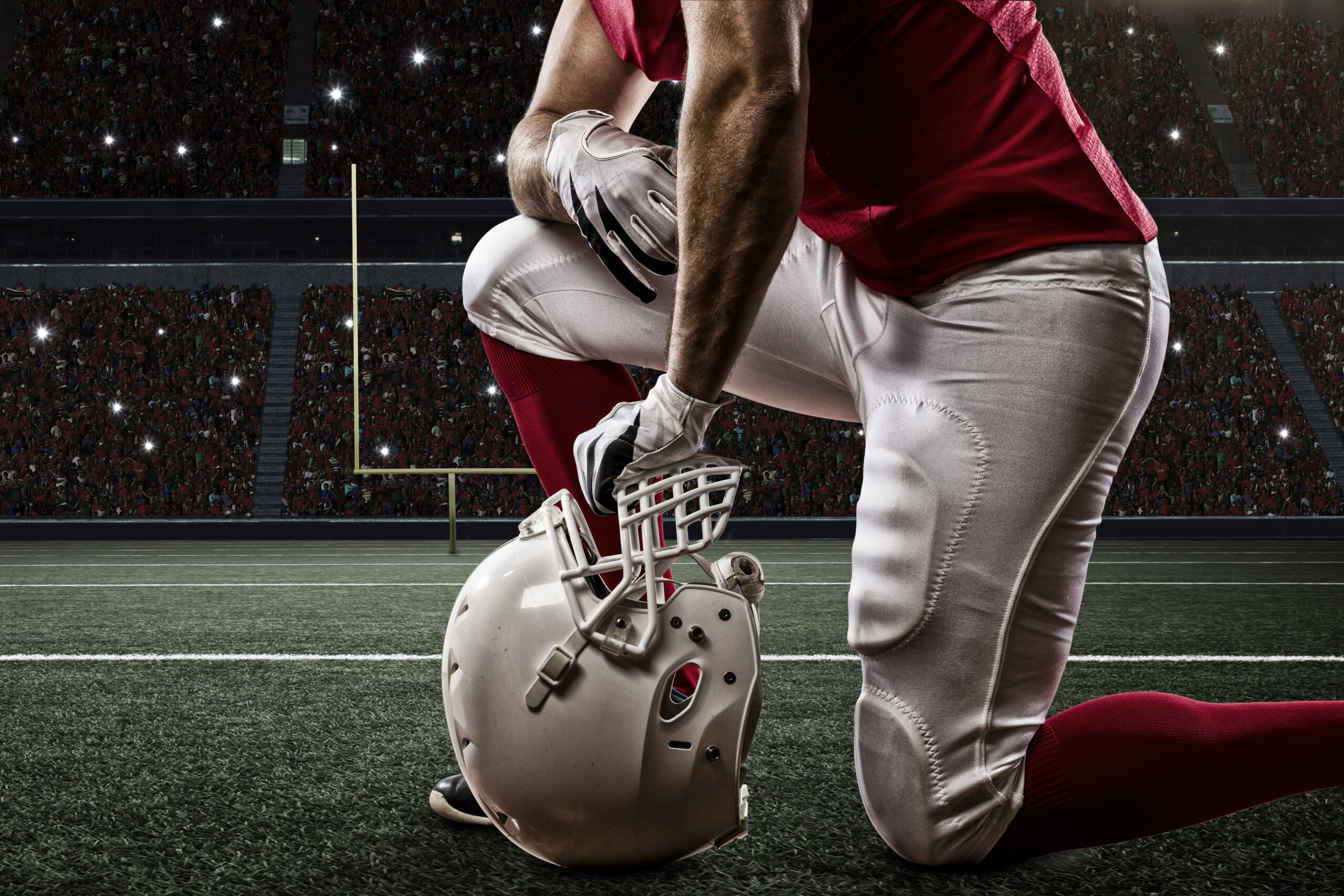 Football Player taking a knee on the field