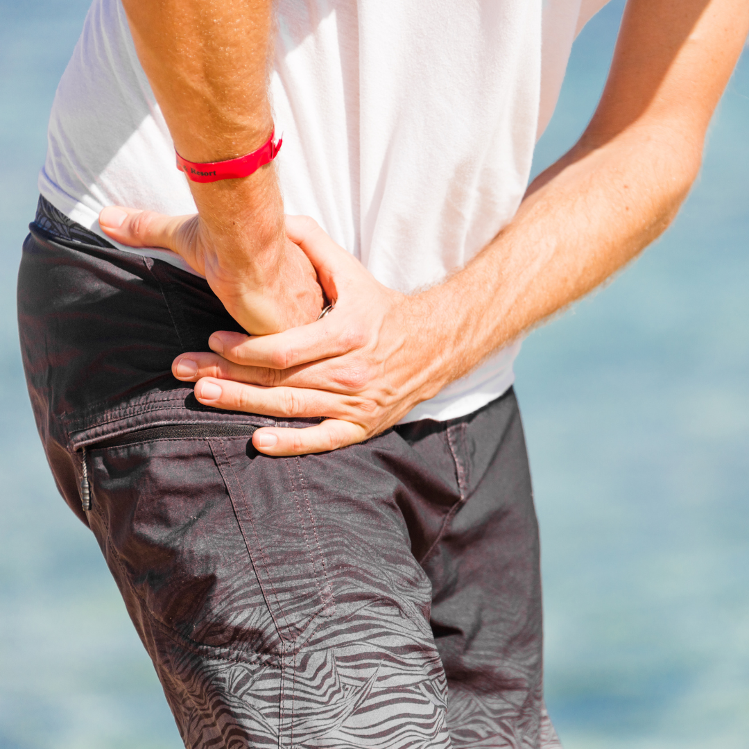 man standing on a beach with severe hip pain from hip arthritis