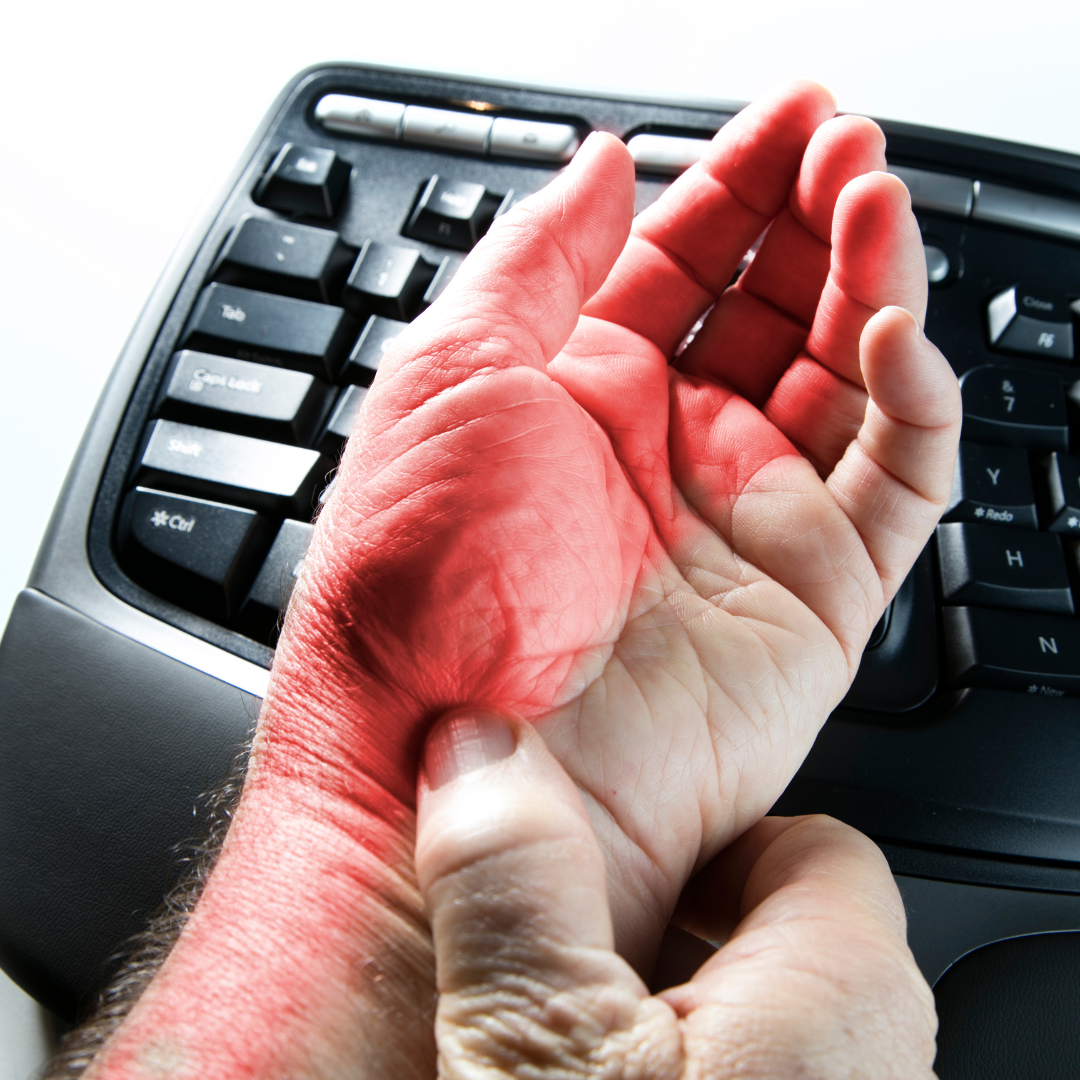 A person suffering from carpal tunnel syndrome from typing at a computer