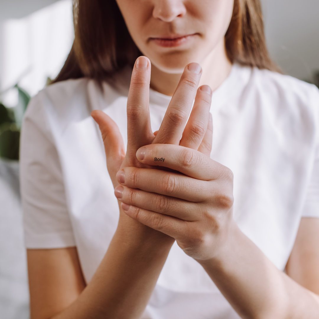 woman holding her hand due to hand pain