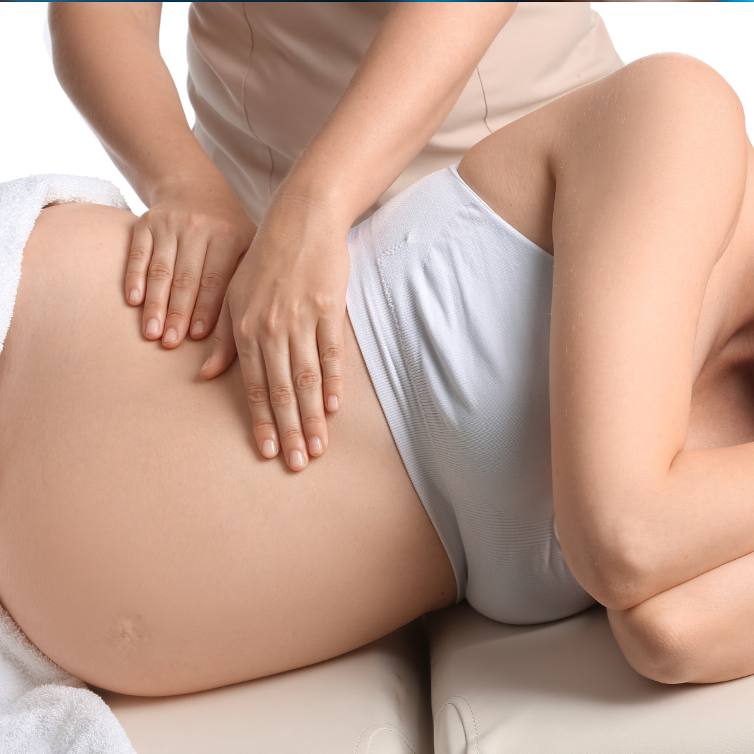 pregnant woman on her side getting a prenatal massage