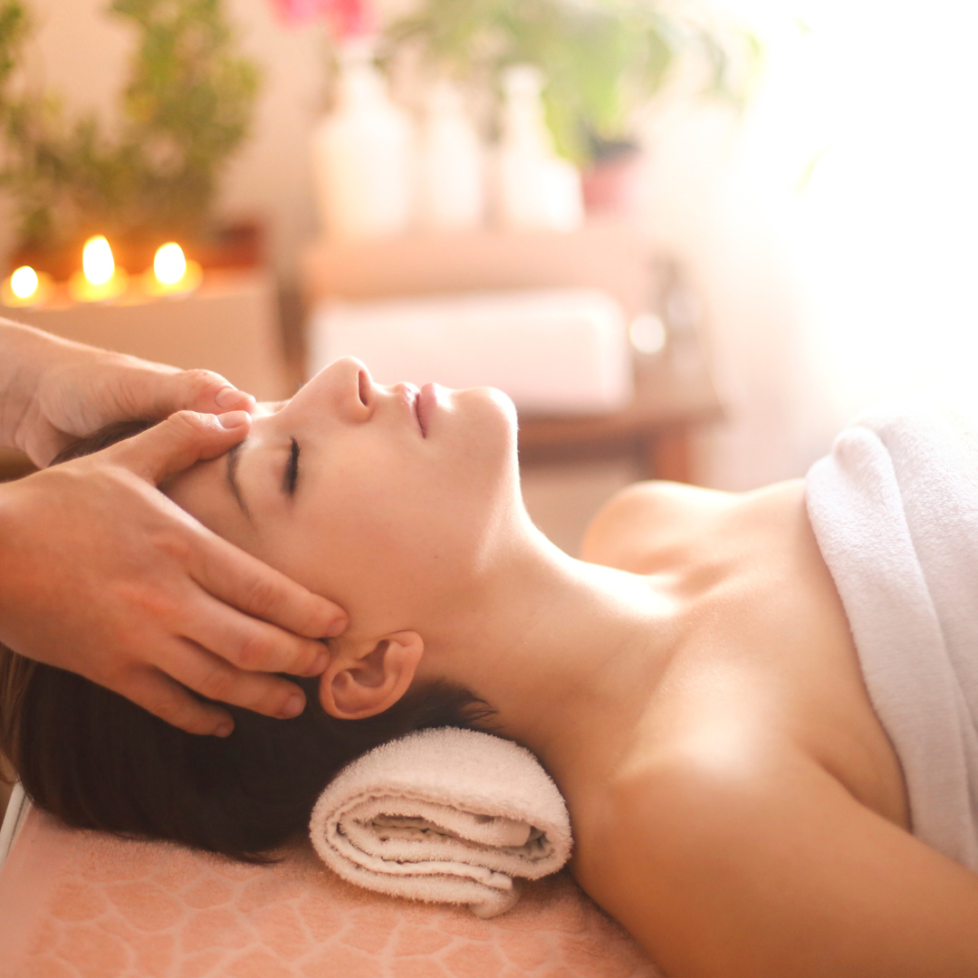 woman laying on her back, getting a relaxation massage