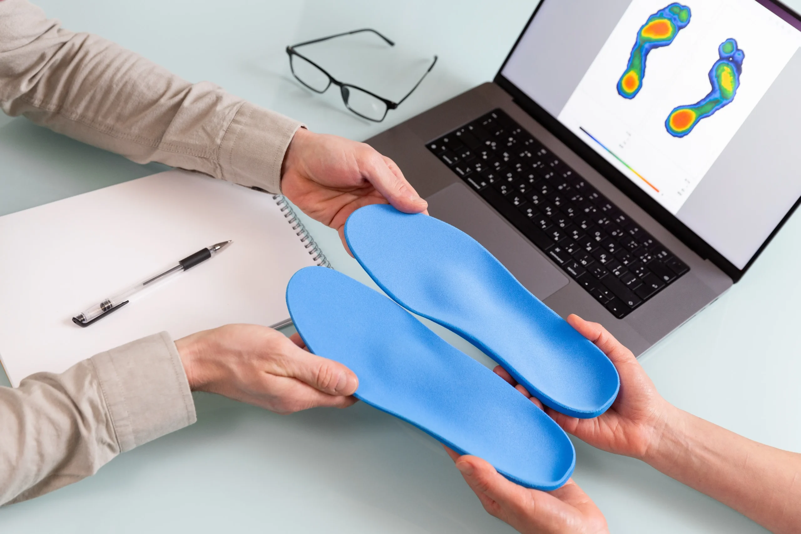 chiropractor making custom orthotics for a patient with foot pain