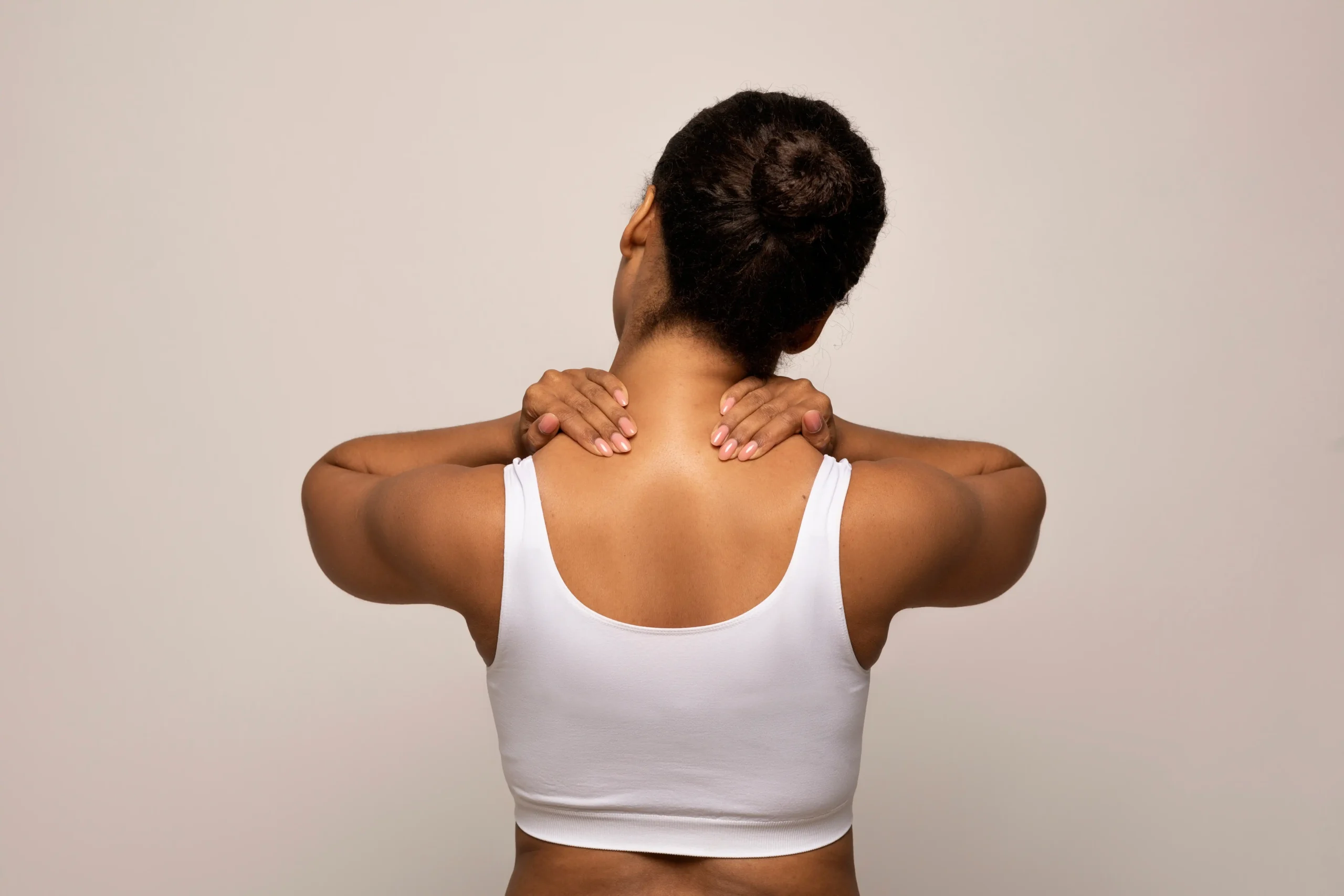 woman with upper back and neck muscular pain