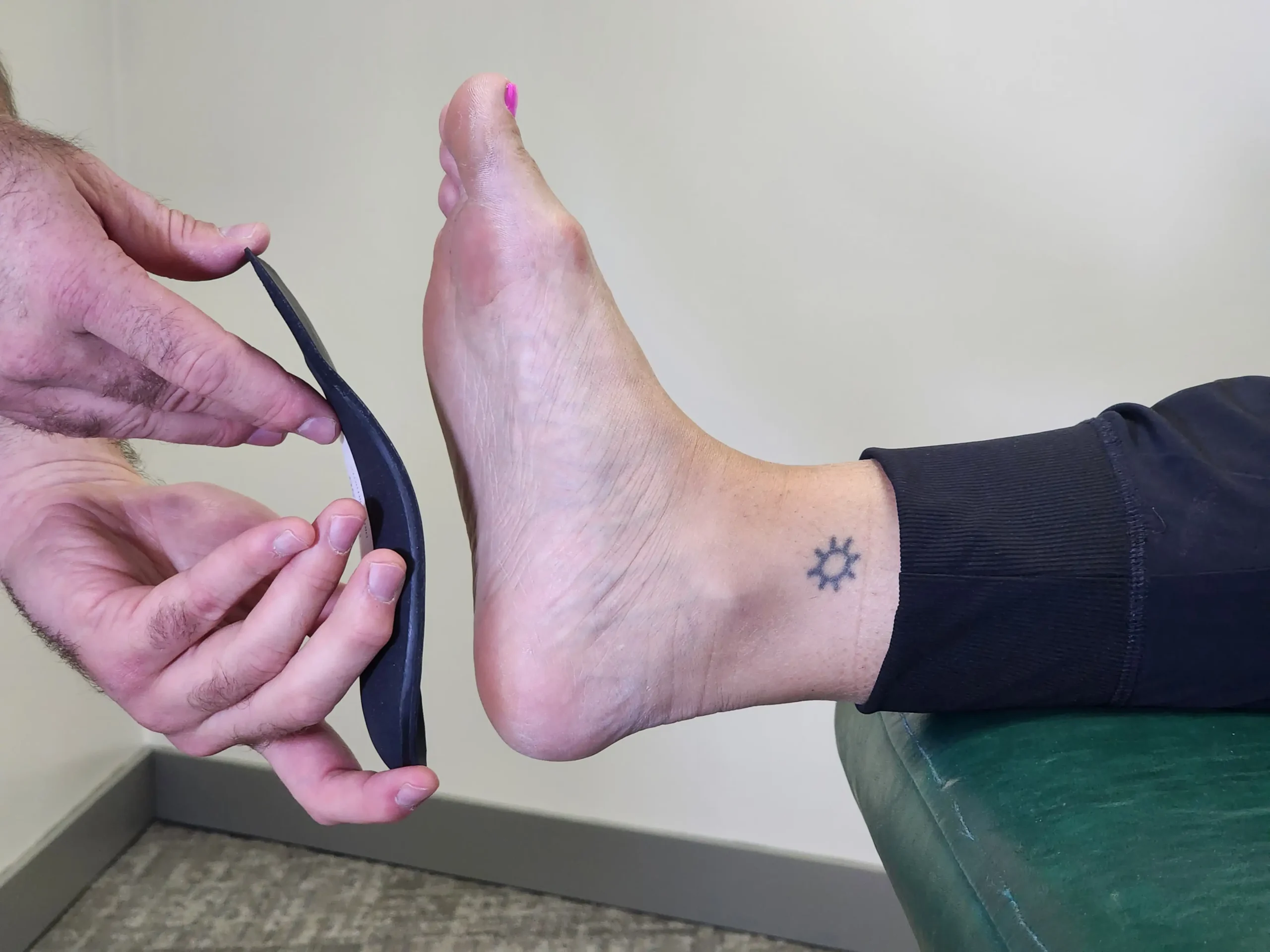woman getting fitted for custom made Edmonton Orthotics at Riverbend Chiropractic & Wellness